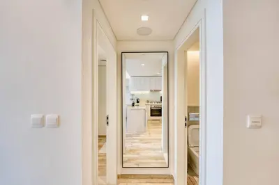 a hallway with a mirror and a kitchen at Classic BNB - Ahad Large 1BR for 4 in Dubai