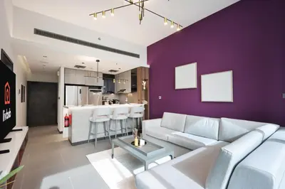 a living room with a white couch and a purple wall at Livbnb-Embrace Luxury and Comfort in Prime 1BR,JLT in Dubai
