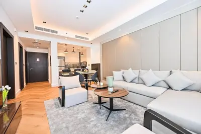 a living room with a white couch and a table at Stunning 1Bdr Luxury with Burj Khalifa View in Dubai