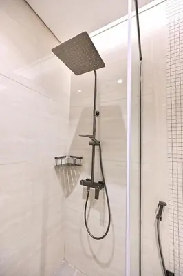 a shower with a shower head in a bathroom at Stunning 1Bdr Luxury with Burj Khalifa View in Dubai