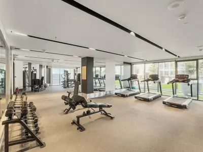 a gym with a lot of treadmills and machines at Stunning 1Bdr Luxury with Burj Khalifa View in Dubai