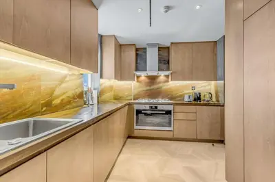 a kitchen with wooden cabinets and a sink at luxury penthouses see view at five in Dubai