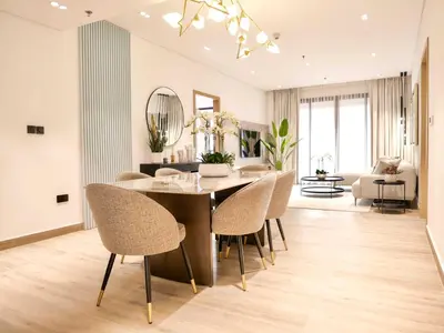 a dining room with a table and chairs at Fresh 3BR Apartment in 5-star Resort in Dubai