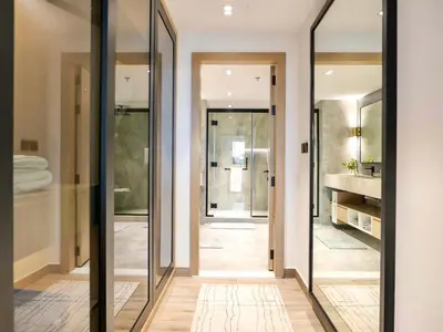 a bathroom with large mirrors in a hallway at Fresh 3BR Apartment in 5-star Resort in Dubai