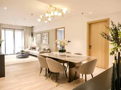 a dining room and living room with a table and chairs at Fresh 3BR Apartment in 5-star Resort in Dubai