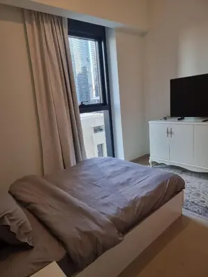 a bedroom with a bed and a window with a television at Luxury 2 Bedroom Act 1 Apartment in Dubai