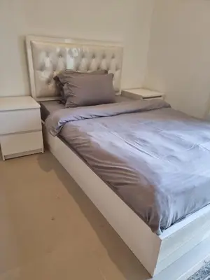 a large bed with two night stands next to it at Luxury 2 Bedroom Act 1 Apartment in Dubai