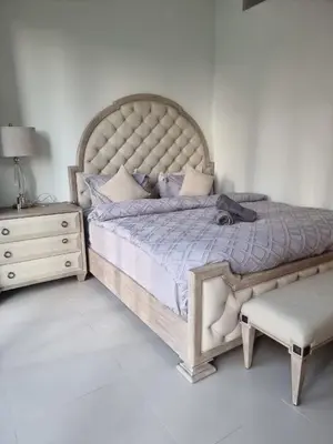 a bedroom with a large bed and a chair at Luxury 2 Bedroom Act 1 Apartment in Dubai