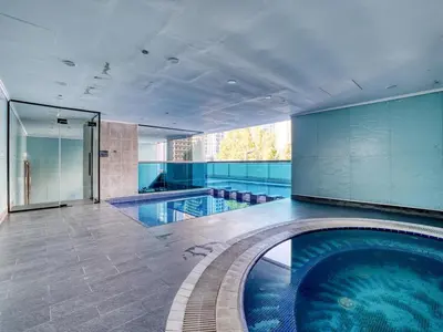 a large swimming pool in a building at Classic Orra Marina-1BR in Dubai