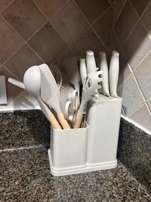a container of kitchen utensils sitting on a counter at Dubai mall Aparment in Dubai