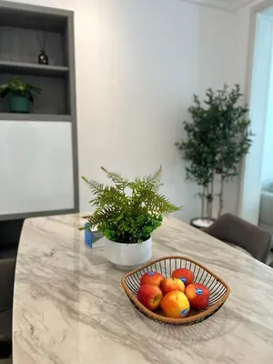 a bowl of fruit sitting on a table at Dubai mall Aparment in Dubai