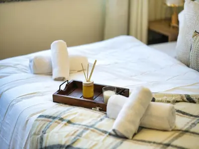 a tray with towels and chopsticks on a bed at Classic Sky Studio Bright in Dubai