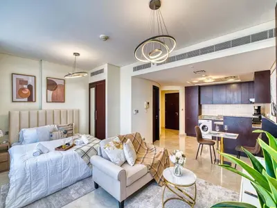 a living room with a couch and a table at Classic Sky Studio Bright in Dubai