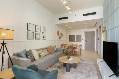 a living room with a couch and a table at Stylish 3 Bedroom in JVC in Dubai