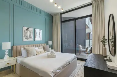 a bedroom with a large bed and a large window at Stylish 3 Bedroom in JVC in Dubai