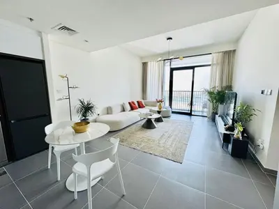 a living room with a couch and a table at Creek edge,1 bedroom apartment, creek Harbour, high Floor in Dubai