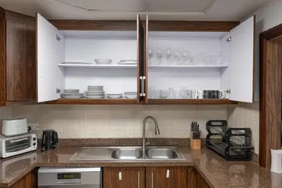 a kitchen with white cabinets and a sink and a microwave at 3BR plus Maid Executive Tower L, City View in Dubai