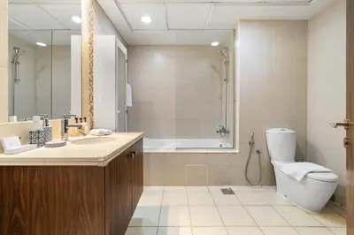 a bathroom with a toilet and a sink and a shower at 3BR plus Maid Executive Tower L, City View in Dubai