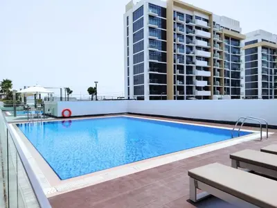 a swimming pool on the roof of a building at Pet Free Studio Apartment Close Downtown Fast Wi-fi in Dubai