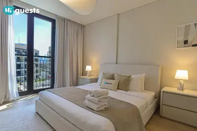 a bedroom with a large bed with towels on it at HiGuest - Coastal Luxury 2BR in La Mer Beachside Bliss in Dubai