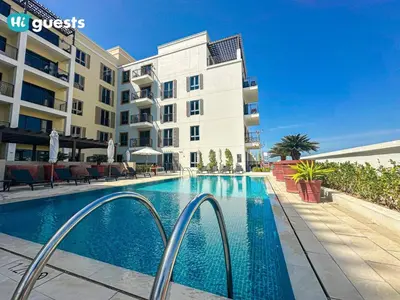 a swimming pool in front of a apartment building at HiGuest - Coastal Luxury 2BR in La Mer Beachside Bliss in Dubai