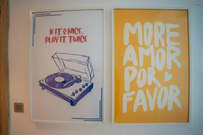 a book with a picture of a typewriter next to posters at Bnbeyond's Sheek Studio at Studio One tower in Dubai