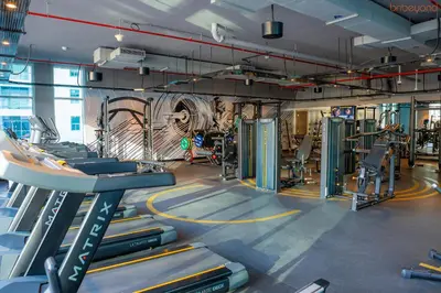 a gym with treadmills and machines in a room at Bnbeyond's Sheek Studio at Studio One tower in Dubai