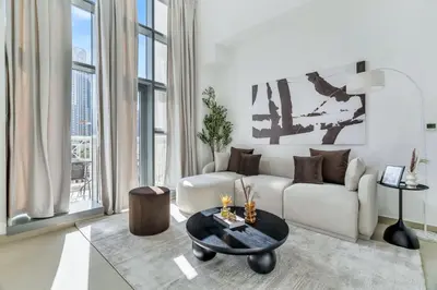 a living room with a white couch and a table at GuestReady - Luxe 1BD Near Dubai Mall | 29 Blvd in Dubai
