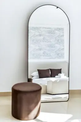 a bedroom with a bed and a mirror at GuestReady - Luxe 1BD Near Dubai Mall | 29 Blvd in Dubai