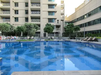 a large swimming pool in front of a building at GuestReady - Luxe 1BD Near Dubai Mall | 29 Blvd in Dubai