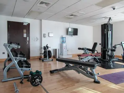 a gym with several tread machines in a room at GuestReady - Luxe 1BD Near Dubai Mall | 29 Blvd in Dubai