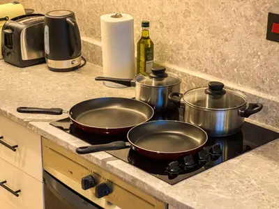 two pots and pans on a stove in a kitchen at Stylish Luxury in the Heart of DIFC in Dubai