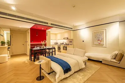 a bedroom with a large bed and a kitchen at Stylish Luxury in the Heart of DIFC in Dubai