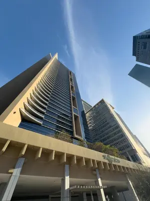 a tall building with a blue sky in the background at Stylish Luxury in the Heart of DIFC in Dubai