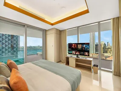 a bedroom with a large bed and a large window at 1BR Suite FIVE LUXE - Pool & Beach view - Private Hot Tub - Ventura Stays in Dubai