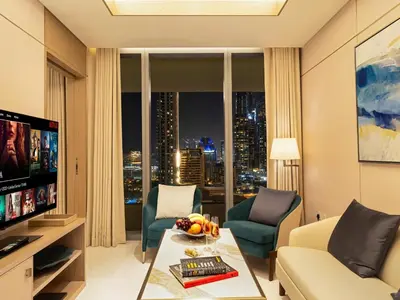a living room with a view of a city at 1BR Suite FIVE LUXE - Pool & Beach view - Private Hot Tub - Ventura Stays in Dubai