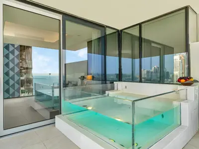a glass house with a hot tub on the balcony at 1BR Suite FIVE LUXE - Pool & Beach view - Private Hot Tub - Ventura Stays in Dubai
