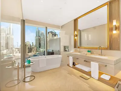 a bathroom with a tub and two sinks and a large window at 1BR Suite FIVE LUXE - Pool & Beach view - Private Hot Tub - Ventura Stays in Dubai