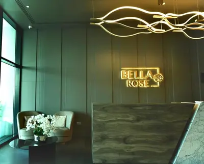 a lobby with a table and a sign that reads belkarosis at Fully Furnished Elegant Studio Apartment Close by Dubai Science Park, Dubai Miracle Garden, Butterfly Garden and Dubai Hills Mall in Dubai