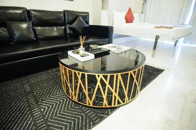 a black and gold coffee table in a living room at Luxury Studio Bayz By Danube Business Bay Marasi Drive Dubai in Dubai