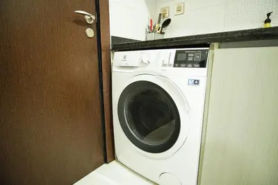 a washing machine in a kitchen next to a counter at Luxury Studio Bayz By Danube Business Bay Marasi Drive Dubai in Dubai