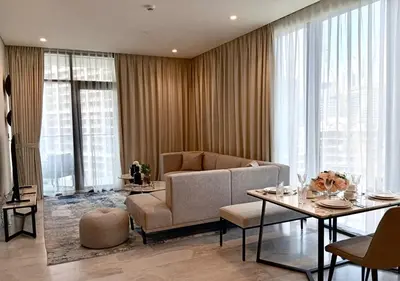 a living room with a couch and a table at Bespoke Holiday Homes - Luxury 1BR in High Floor with Stunning Canal Views in Dubai