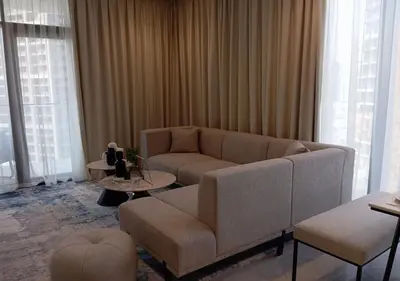 a living room with a couch and a table at Bespoke Holiday Homes - Luxury 1BR in High Floor with Stunning Canal Views in Dubai