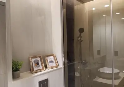 a bathroom with a glass shower and a sink at Bespoke Holiday Homes - Luxury 1BR in High Floor with Stunning Canal Views in Dubai