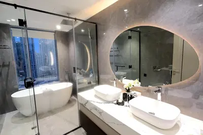 a bathroom with two sinks and a shower at JW Marriott Stylish 1BR - Marina View - Direct Dubai Marina Mall Access - Pool & Gym - Free Parking in Dubai