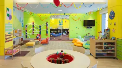 a room with a playroom with a table and a play area at JW Marriott Stylish 1BR - Marina View - Direct Dubai Marina Mall Access - Pool & Gym - Free Parking in Dubai