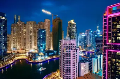 a view of a city skyline at night at JW Marriott Stylish 1BR - Marina View - Direct Dubai Marina Mall Access - Pool & Gym - Free Parking in Dubai