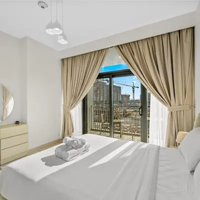 a bedroom with a white bed and a large window at Park Point C-1 bedroom for monthly stay-1004 in Dubai