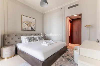 a bedroom with a large bed and a couch at Burj Vista Tower 2, Downtown - Upgarded 2 bedroom in Dubai