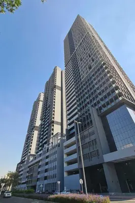 a large building with two tall buildings at Fully Furnished Cozy Studio at JVC Dubai, Short Drive to Dubai Marina, JBR, Downtown Dubai in Dubai